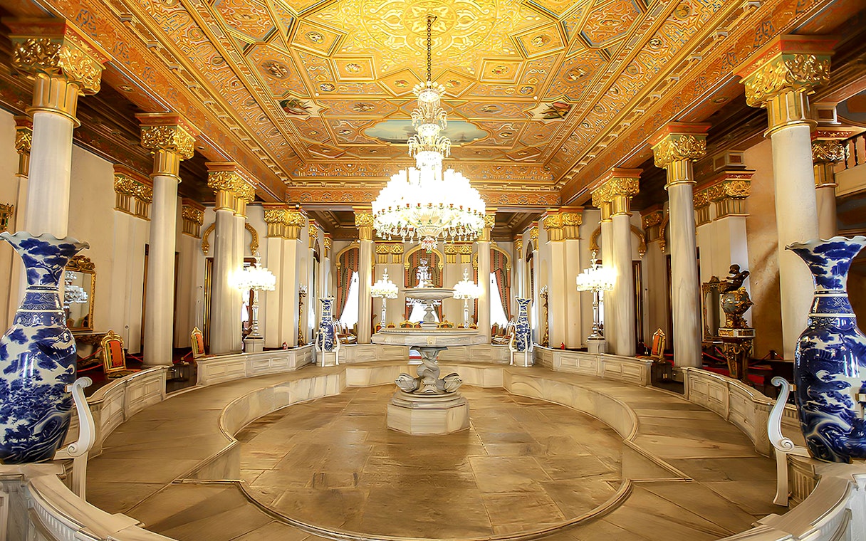 Beylerbeyi Palace interior with ornate ceiling, chandeliers, and decorative columns in Istanbul.