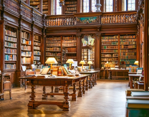 Generic image of a library interior with rows of bookshelves and reading tables, showcasing a quiet study environment.