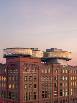 Guinness Storehouse rooftop view with glass-walled Gravity Bar at sunset, Dublin.