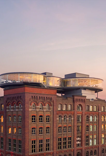 Guinness Storehouse rooftop view with glass-walled Gravity Bar at sunset, Dublin.
