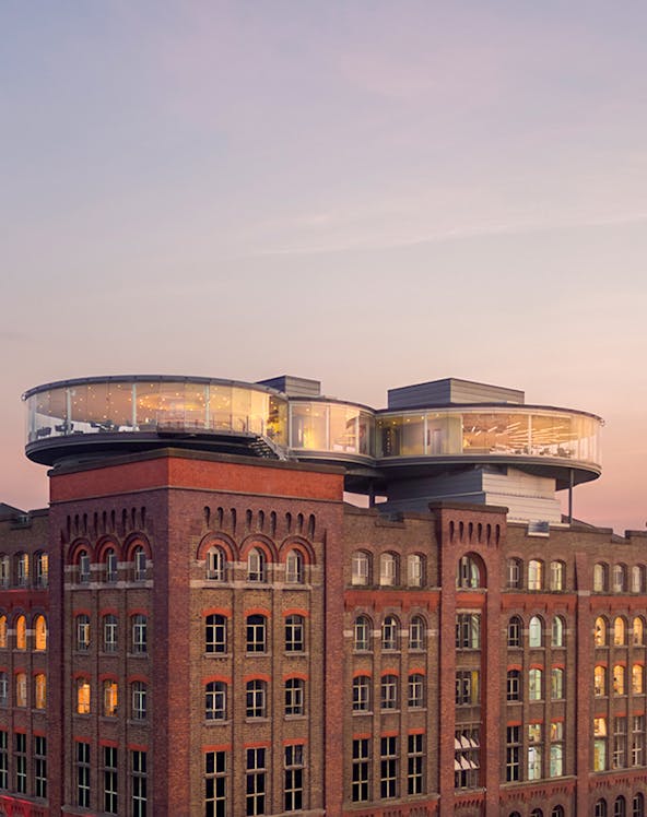 Guinness Storehouse rooftop view with glass-walled Gravity Bar at sunset, Dublin.