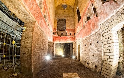 Interior of Domus Aurea with ancient Roman architecture and red frescoes, Rome.