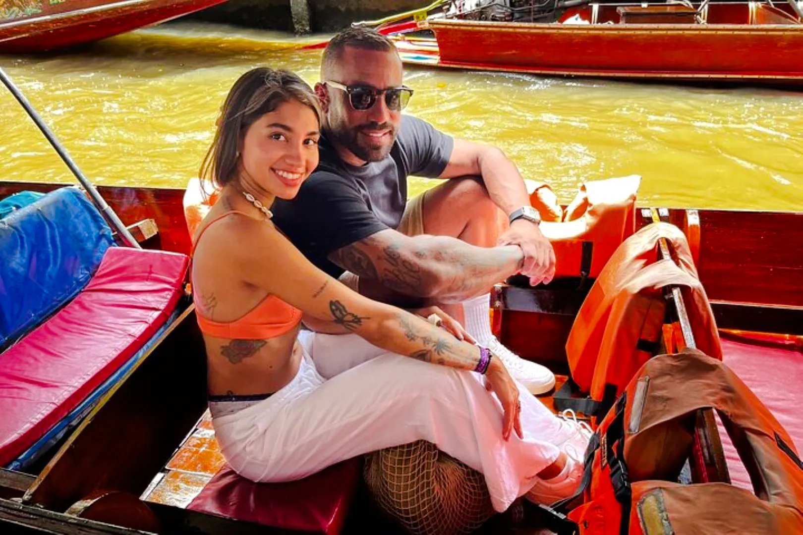 Couple enjoying a boat ride at a floating market during a private tour from Laem Chabang Cruise Port, Pattaya.