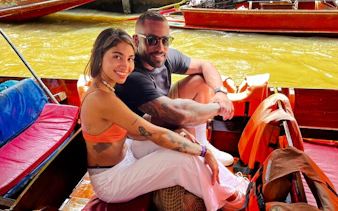Couple enjoying a boat ride at a floating market during a private tour from Laem Chabang Cruise Port, Pattaya.