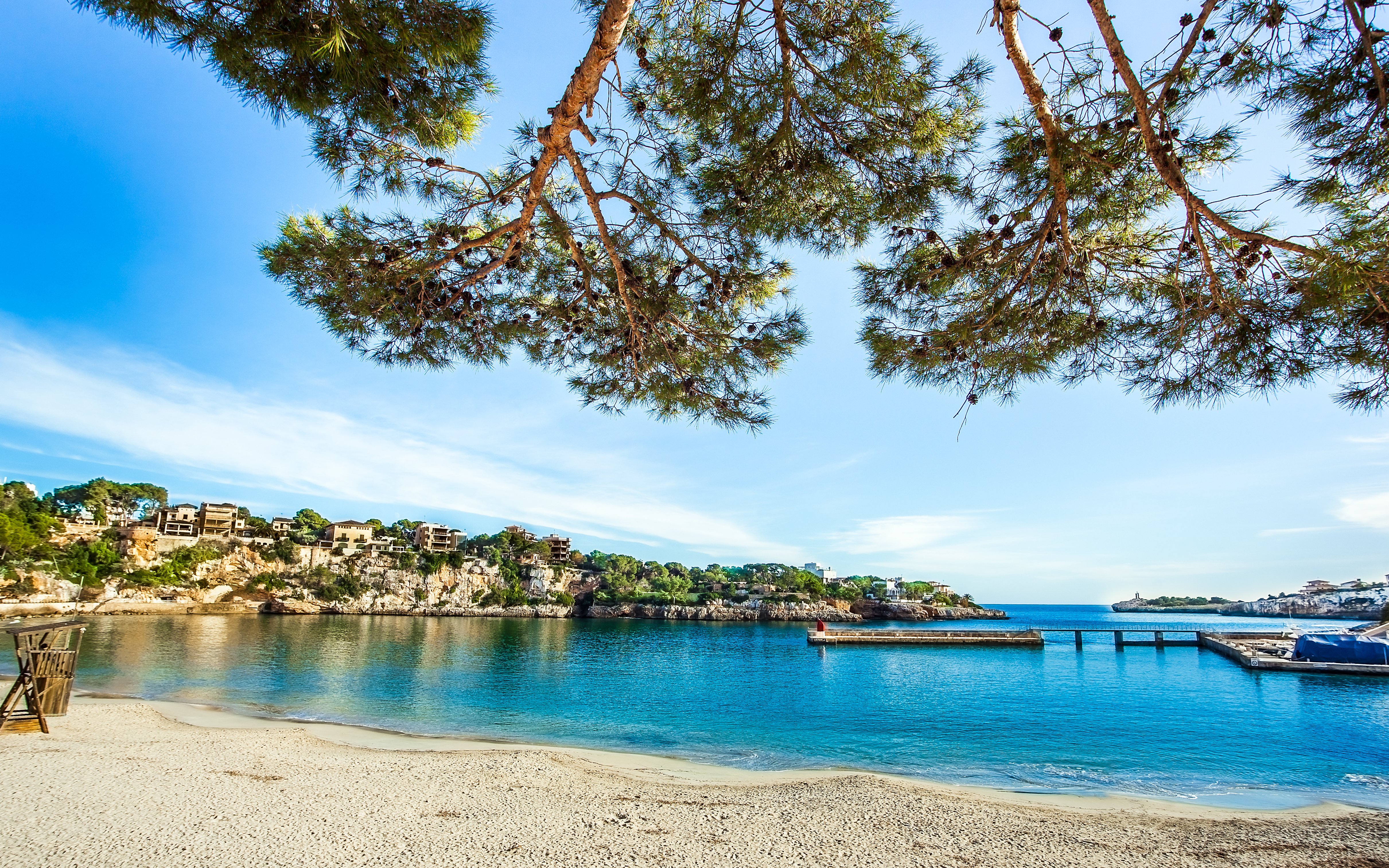 Porto Cristo beach with clear water and rocky cliffs, Mallorca, Spain.