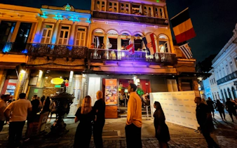 Rio Scenarium facade at night with people gathering outside, Rio de Janeiro.