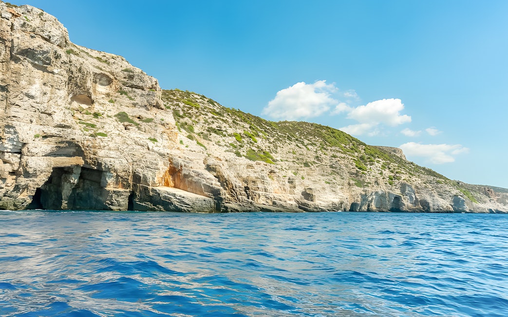 Rugged cliffs and sea caves along the coastline of an island near Split.