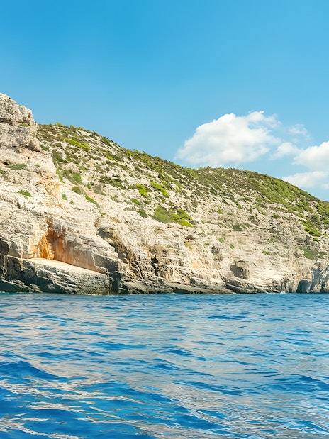 Rugged cliffs and sea caves along the coastline of an island near Split.