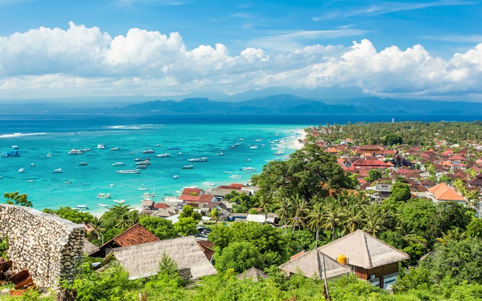 Nusa Lembongan coastline with boats in turquoise water, view from above, Indonesia.