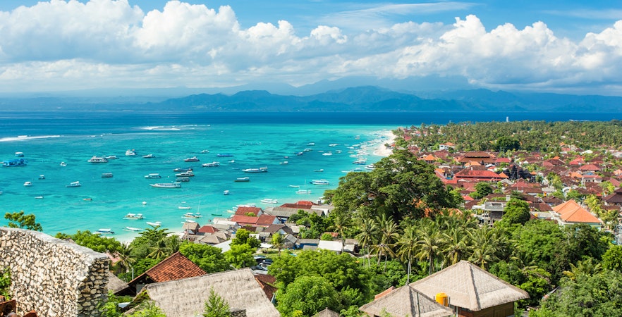 Nusa Lembongan coastline with boats in turquoise water, view from above, Indonesia.