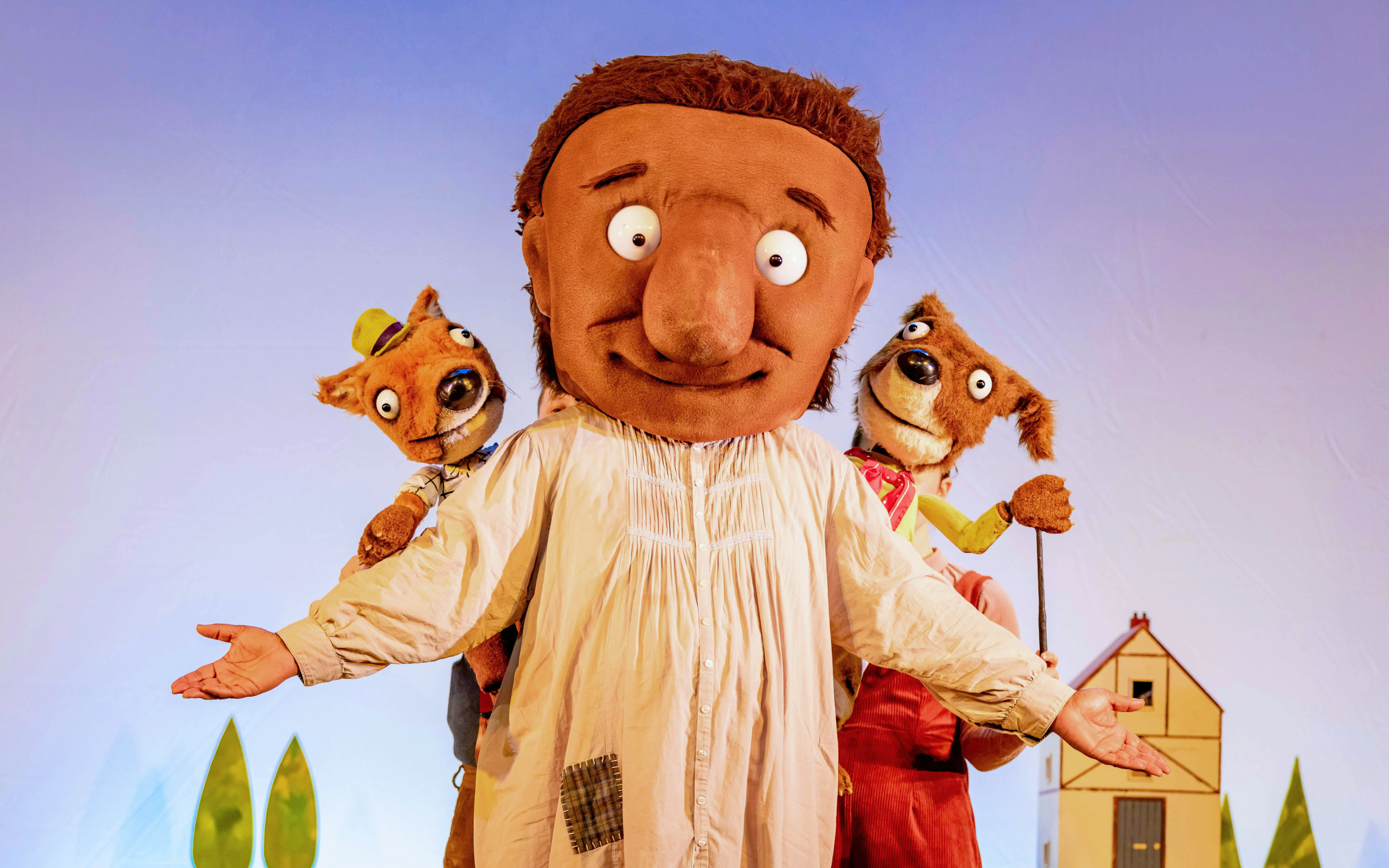 Giant character with animal puppets from "The Smartest Giant in Town" show.