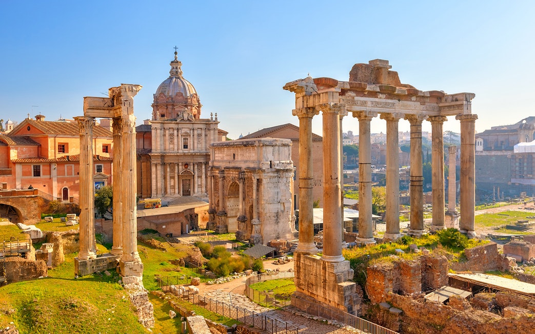 Ancient Roman Forum ruins with columns and historic buildings in Rome, Italy.