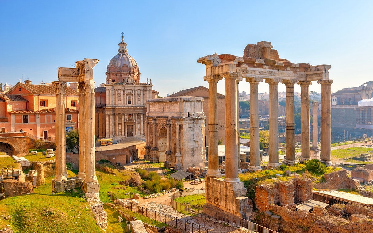 Ancient Roman Forum ruins with columns and historic buildings in Rome, Italy.