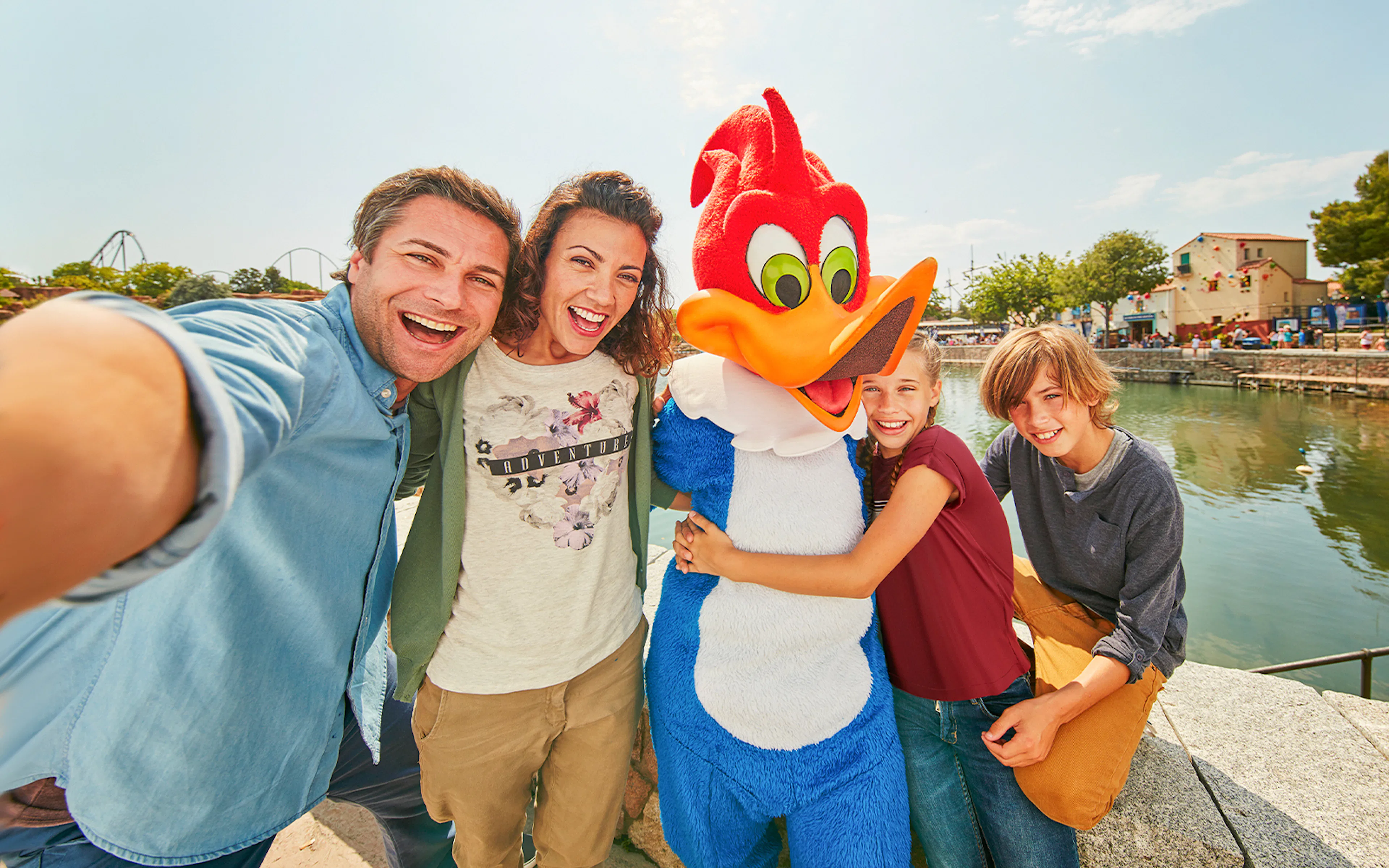 Family taking a selfie with a character at PortAventura World, Barcelona.