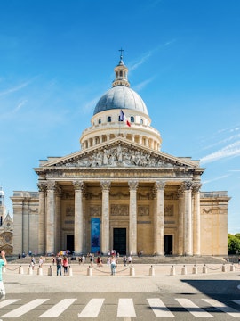 Pantheon in Paris with visitors outside, showcasing neoclassical architecture.