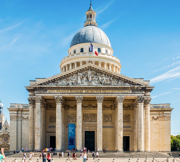 Pantheon in Paris with visitors outside, showcasing neoclassical architecture.