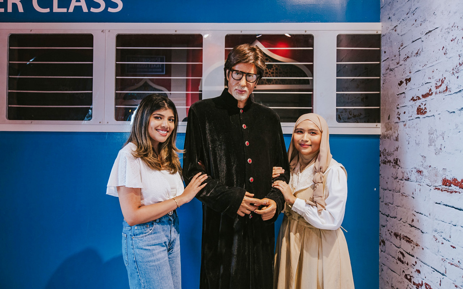 Wax figure of Amitabh Bachchan with visitors at Madame Tussauds Singapore