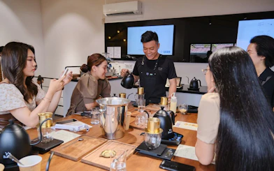 Participants learning coffee brewing techniques in a workshop in Hồ Chí Minh City.