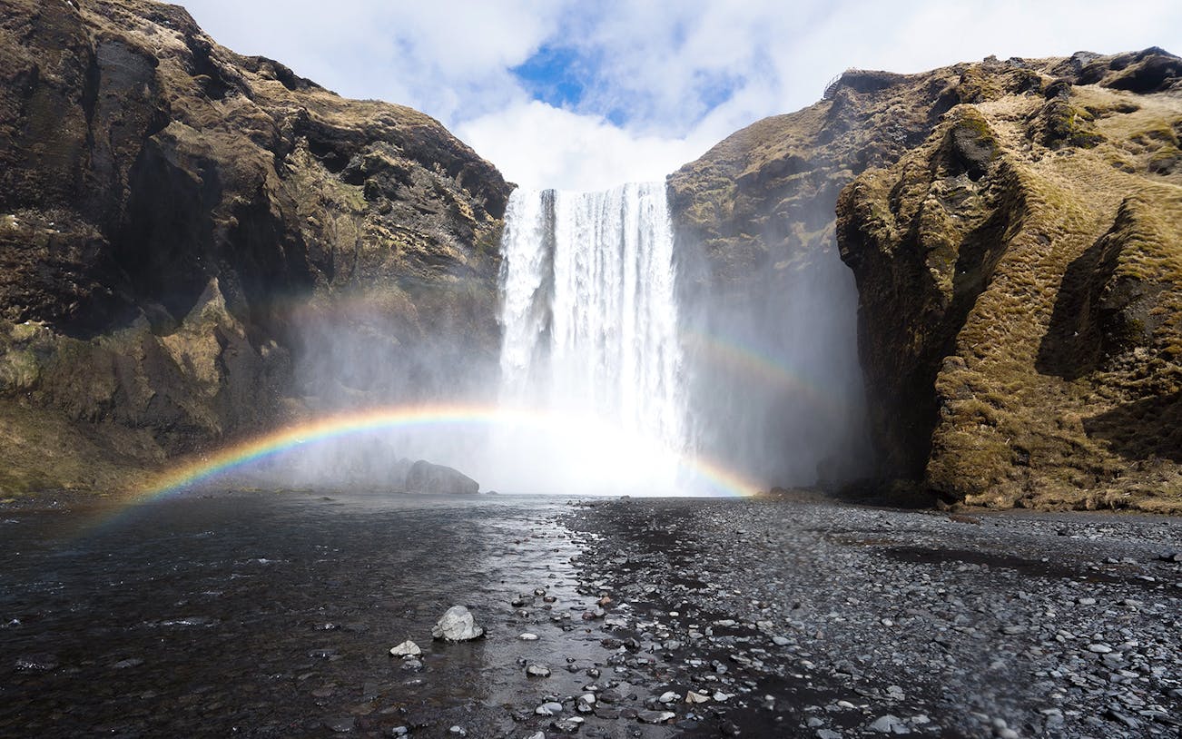 Waterfall with rainbow at Skógafoss, Southern Iceland, part of South Coast & Northern Lights Tour.