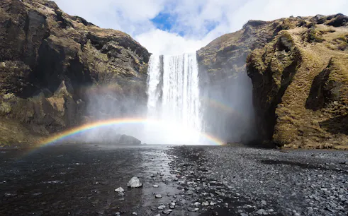 Waterfall with rainbow at Skógafoss, Southern Iceland, part of South Coast & Northern Lights Tour.