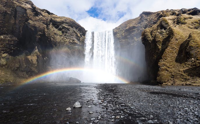 Waterfall with rainbow at Skógafoss, Southern Iceland, part of South Coast & Northern Lights Tour.
