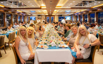 Guests dining on a Bosphorus dinner cruise with Turkish night show in Istanbul.