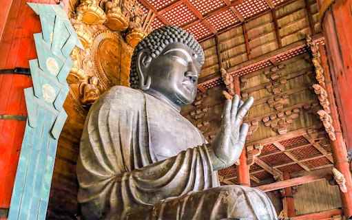 Giant Buddha statue inside Todai-ji Temple, Nara, Japan, part of Nara and Kyoto One-Day Bus Tour.
