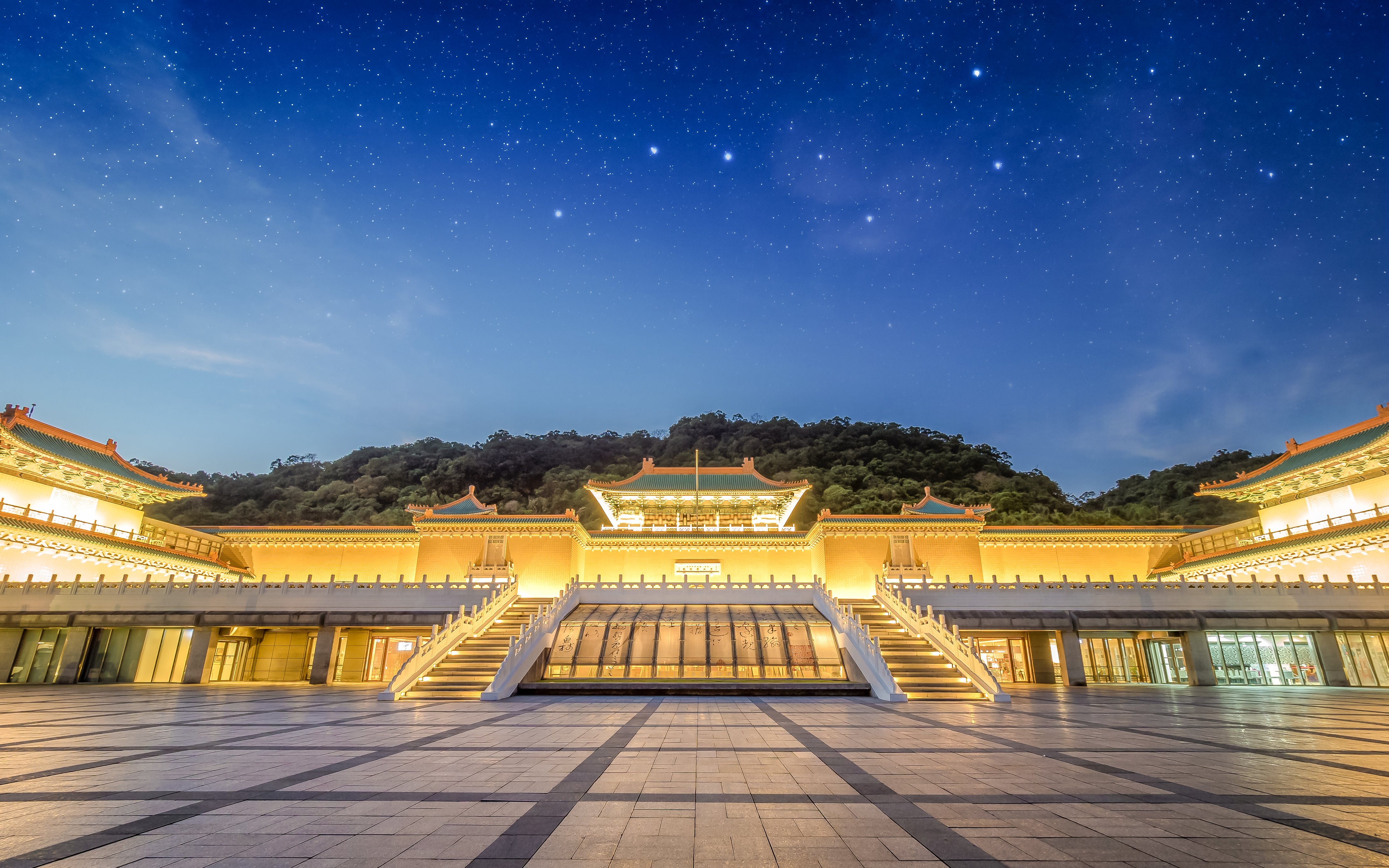 Taiwan Palace Museum illuminated at night with starry sky backdrop.