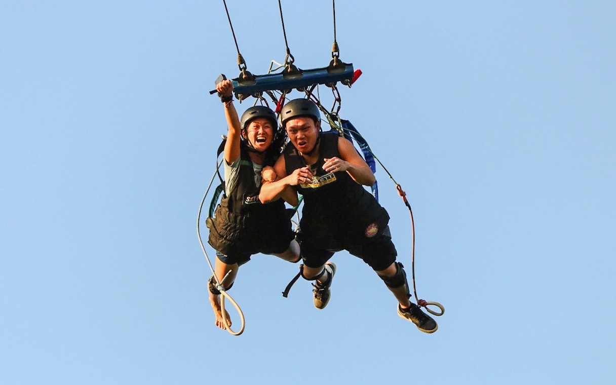 Two people tandem diving at Skypark Sentosa by AJ Hackett.