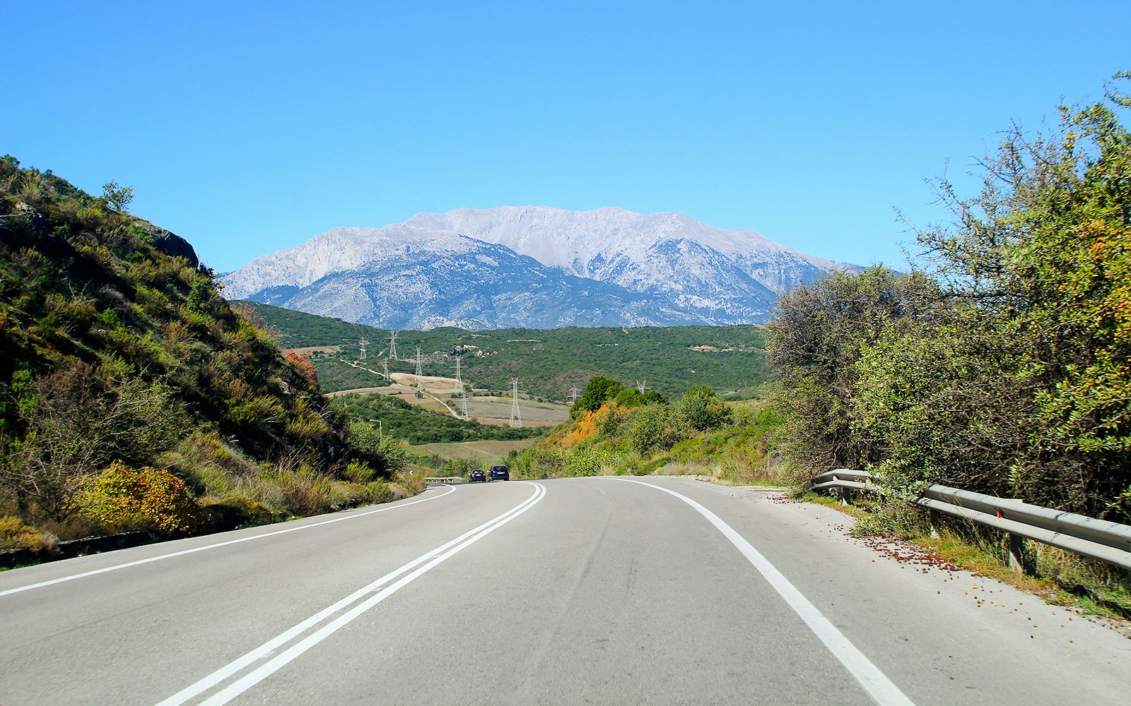 Road leading to Mount Parnassus in Greece with scenic mountain view.