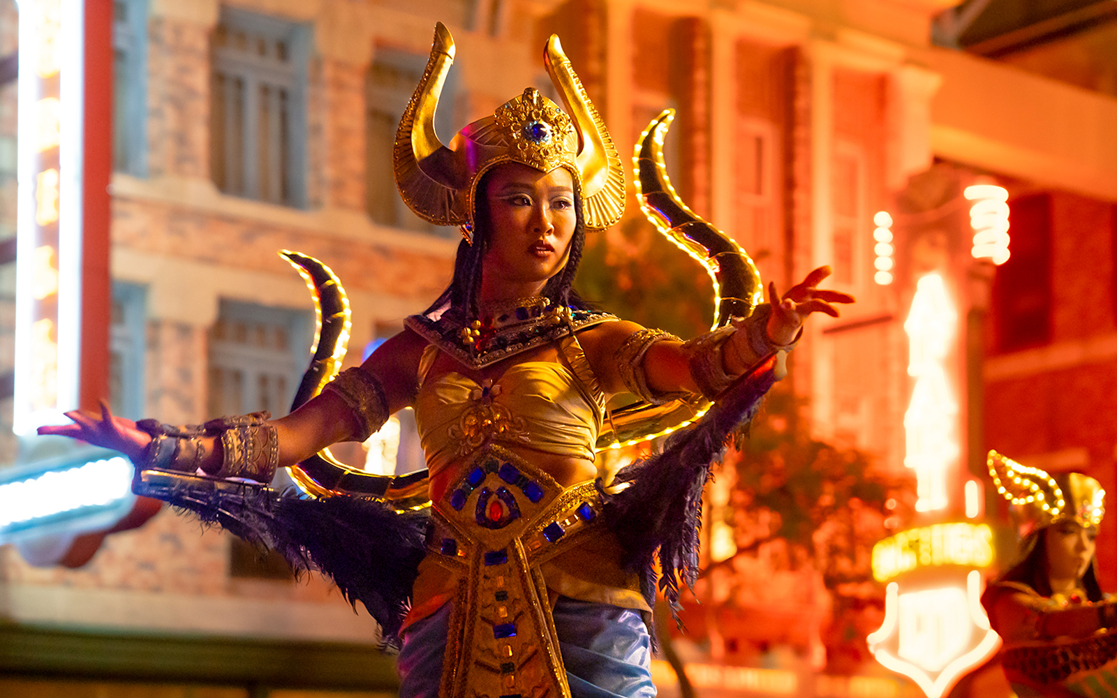 Performer in costume at Universal Studios Singapore nighttime parade.