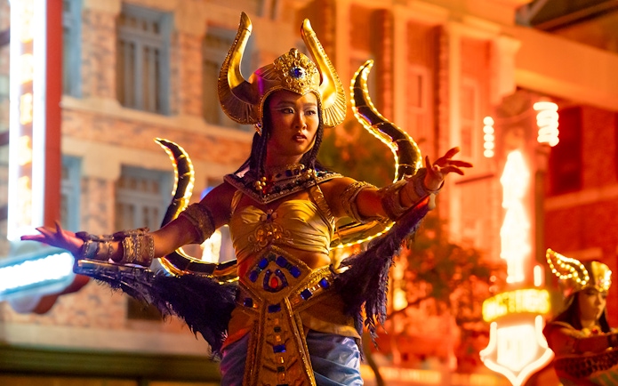 Performer in costume at Universal Studios Singapore nighttime parade.