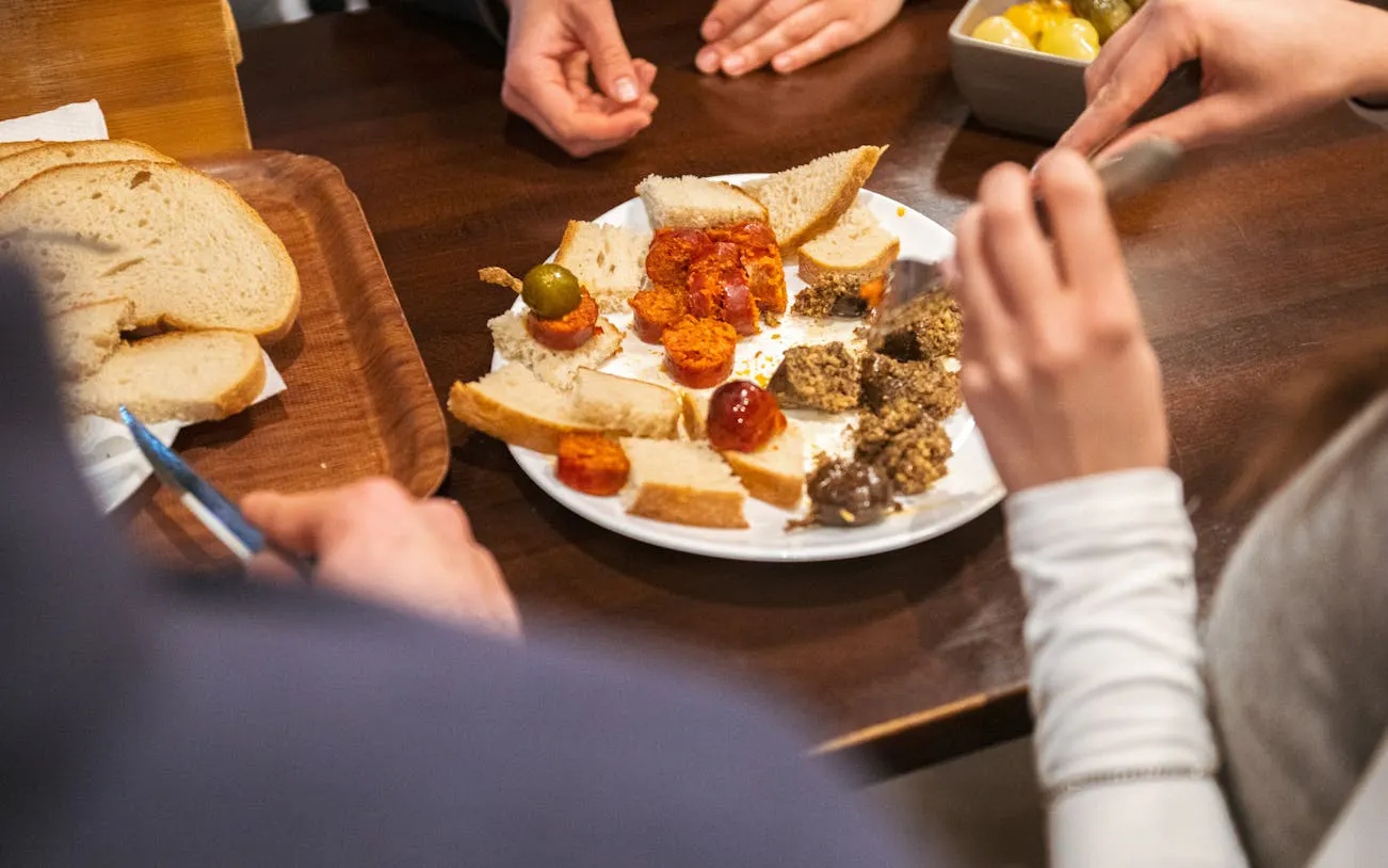 Plate of Hungarian bread, spreads, and sausages on Budapest food tour.