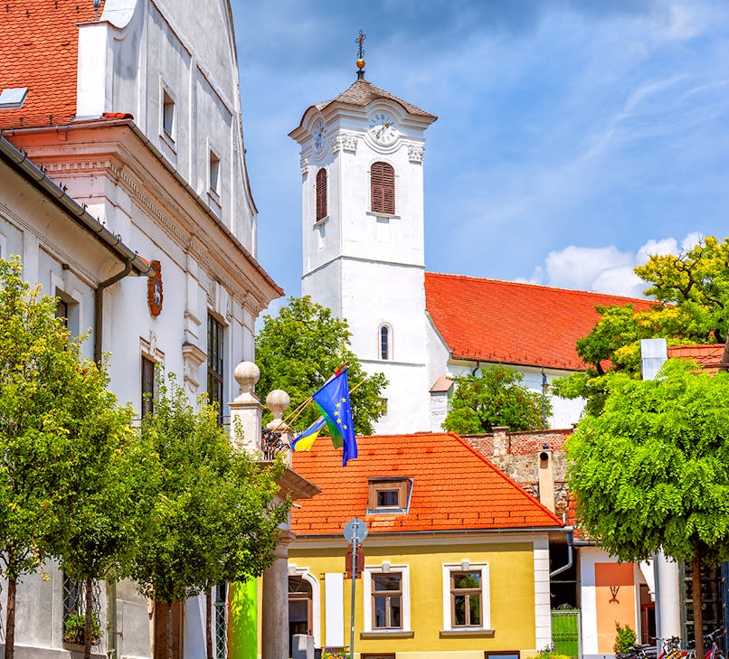 Danube River view with boats and Szentendre's colorful buildings, Budapest to Szentendre tour.