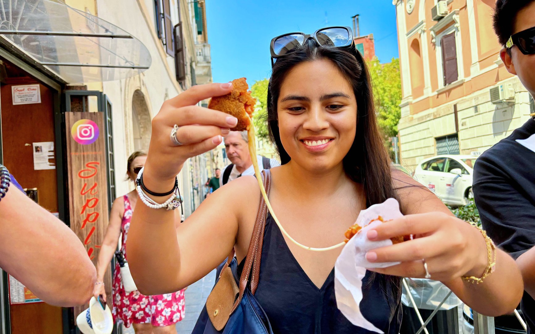 Tourist enjoying street food on Rome Trastevere food tour with local guide.