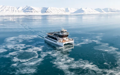 Hybrid electric boat on icy waters during Silent Whale Watching Tour from Tromso.