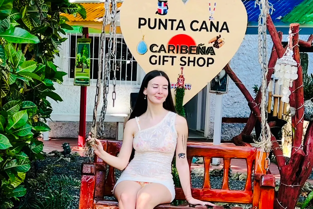 Woman sitting on a swing at Punta Cana Caribeña Gift Shop during a panoramic tour.