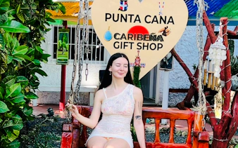 Woman sitting on a swing at Punta Cana Caribeña Gift Shop during a panoramic tour.