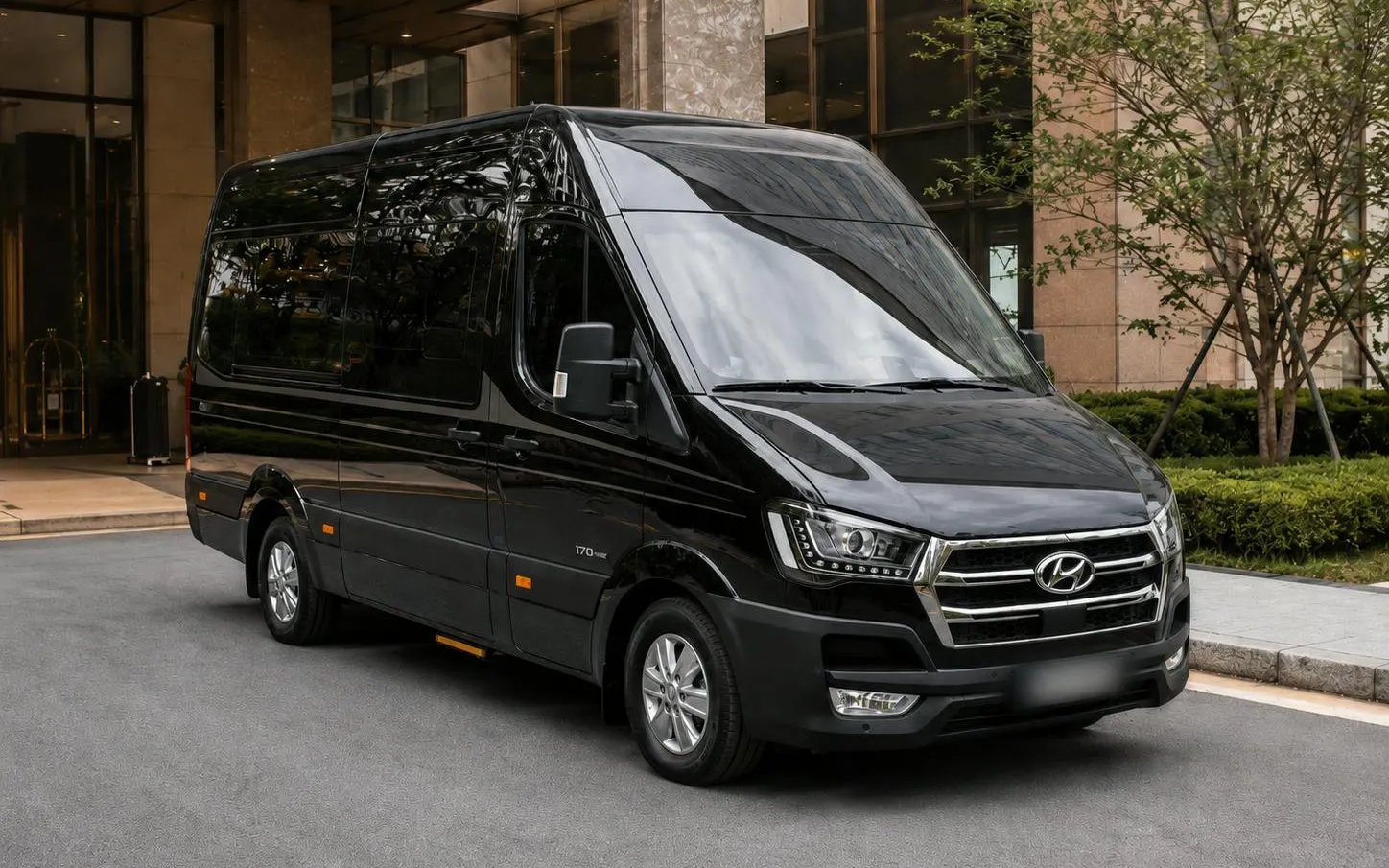 Black tour van parked outside a hotel for DMZ Premium Small Group Tour in North Korea.