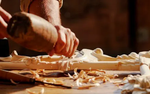 Wood carving in progress at a workshop in Ben Guerir, Marrakesh.