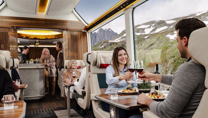 A couple enjoying a glass of Champagne and a tasty aperitif platter.