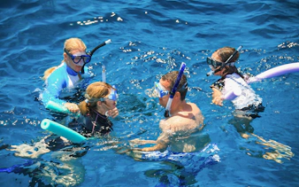 Snorkelers in the water during Port Douglas to Low Isles Island cruise.