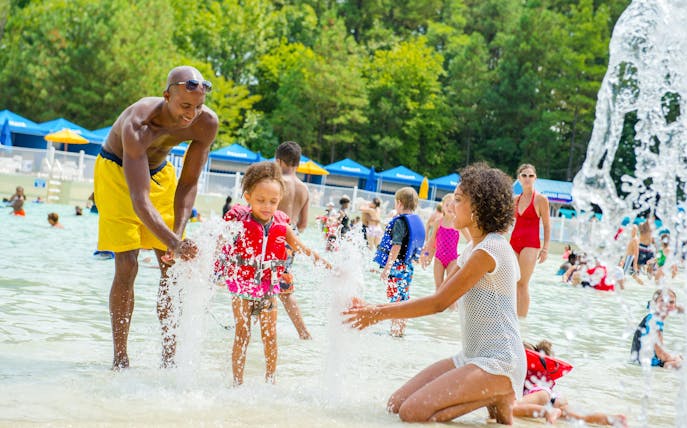 Families enjoying the wave pool at Hurricane Harbor New Jersey.