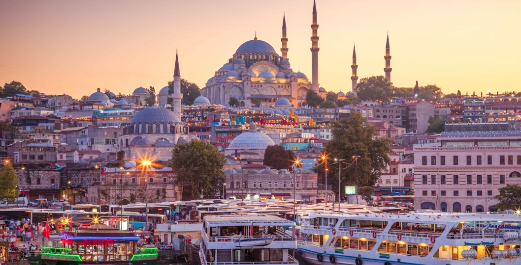 Boats docked at Eminonu Pier with Suleymaniye Mosque in the background, Istanbul.