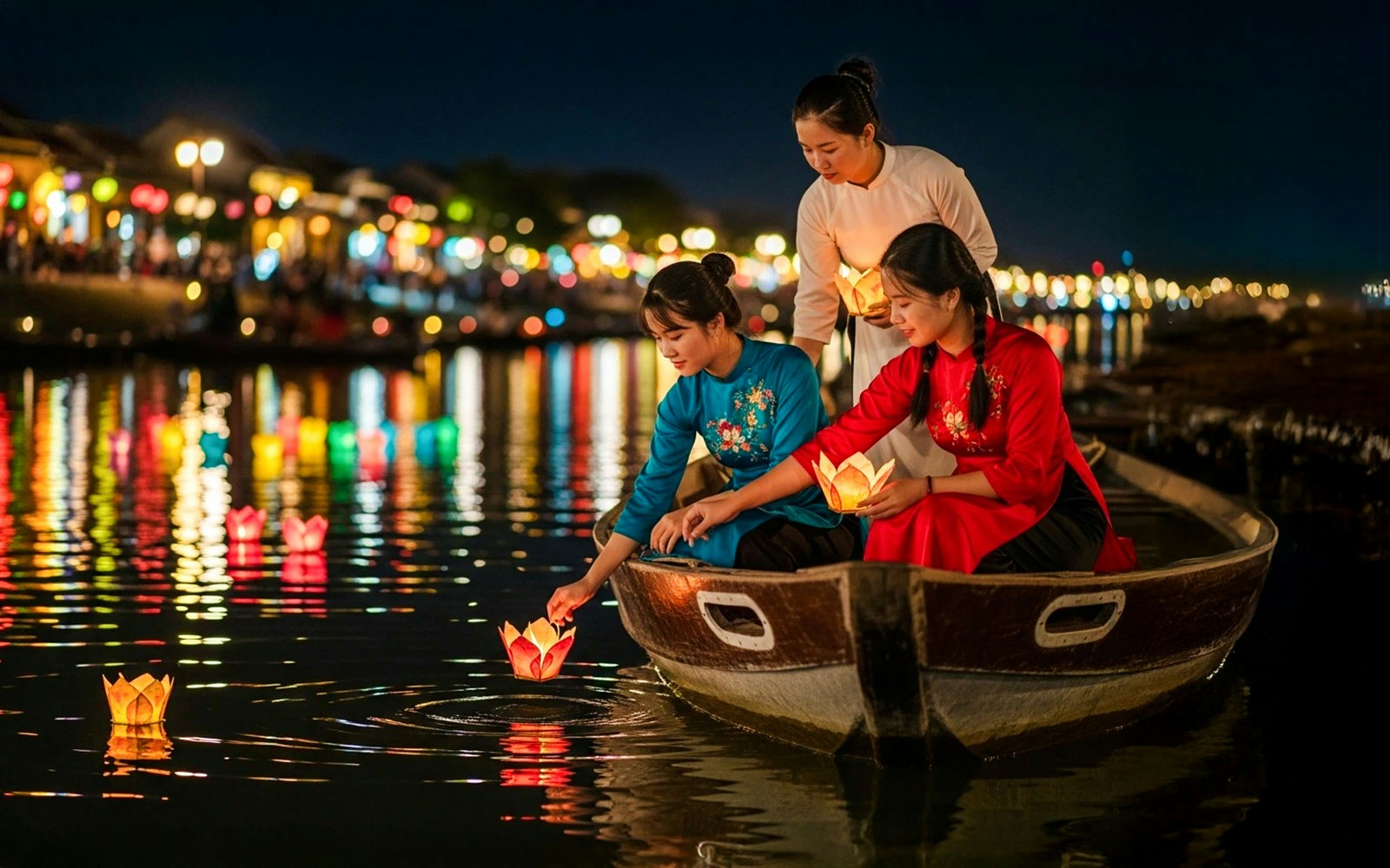 Tourists in a boat releasing lanterns on Hoi An River at night.