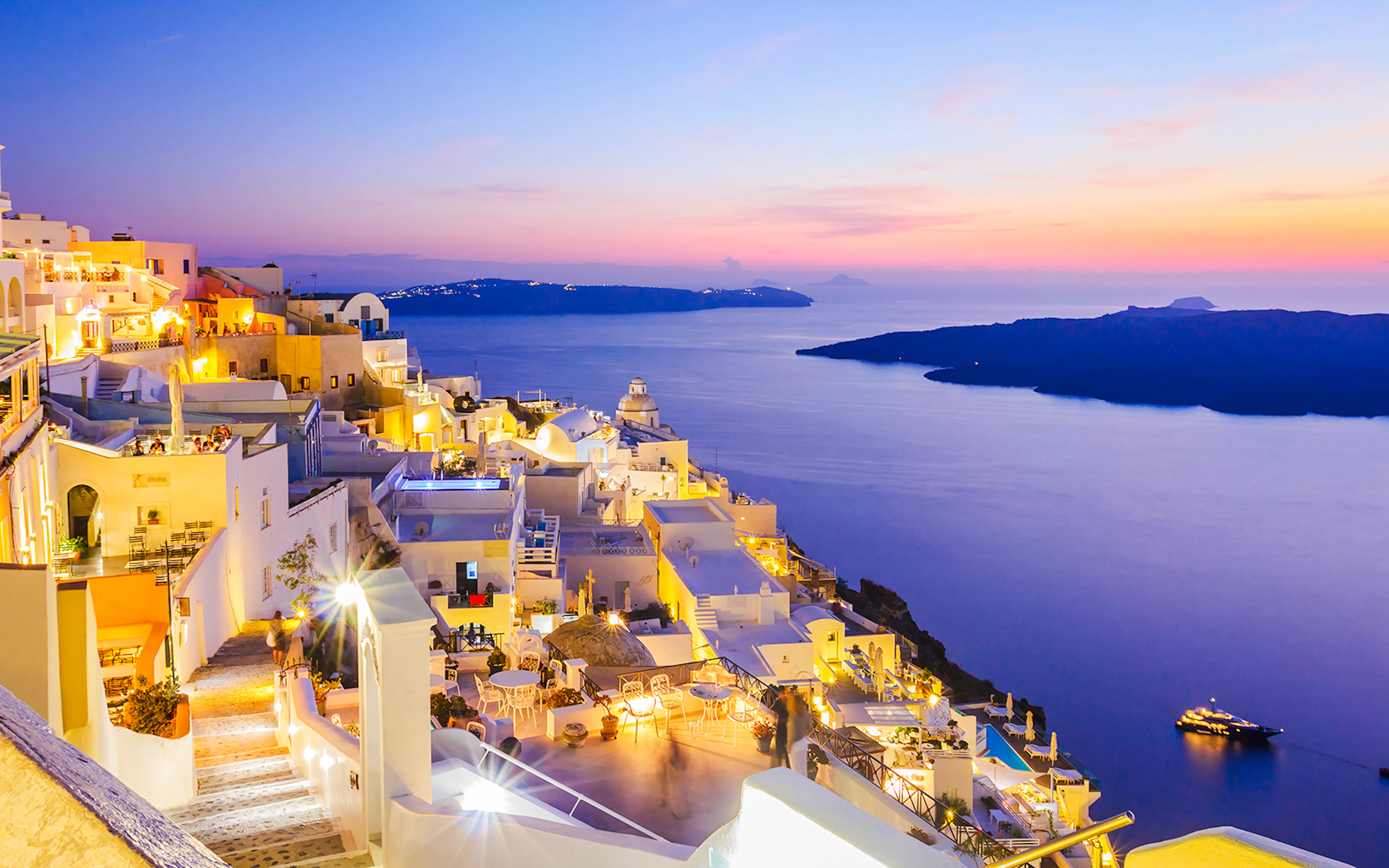 Oia village overlooking the sea at sunset, Santorini, Greece.