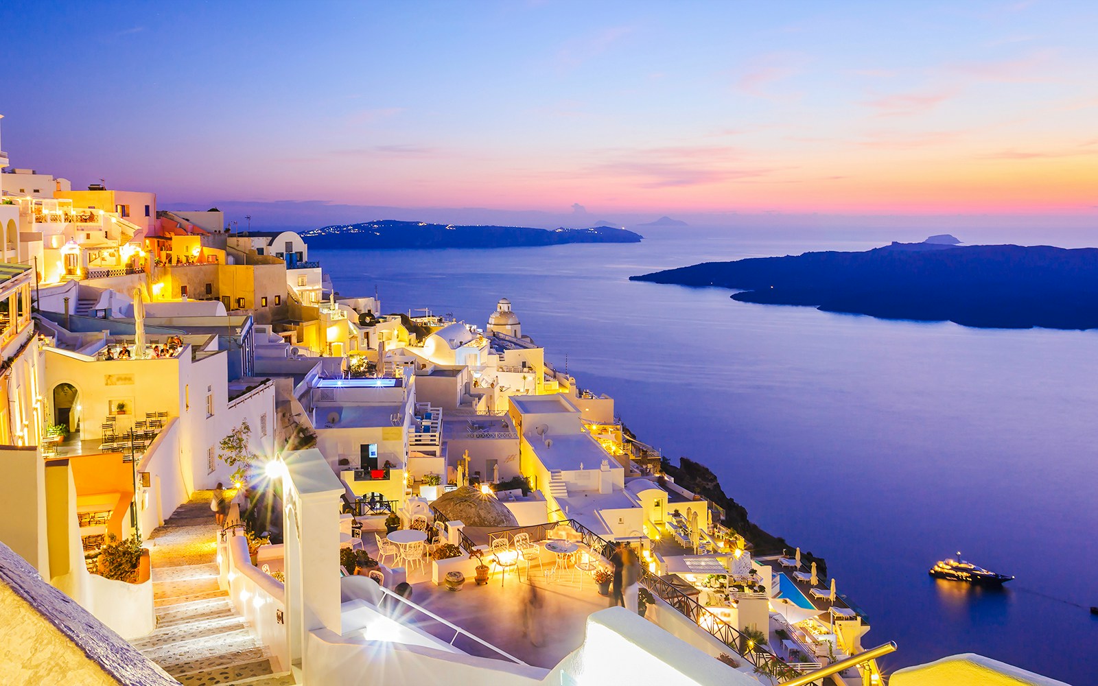 Oia village overlooking the sea at sunset, Santorini, Greece.