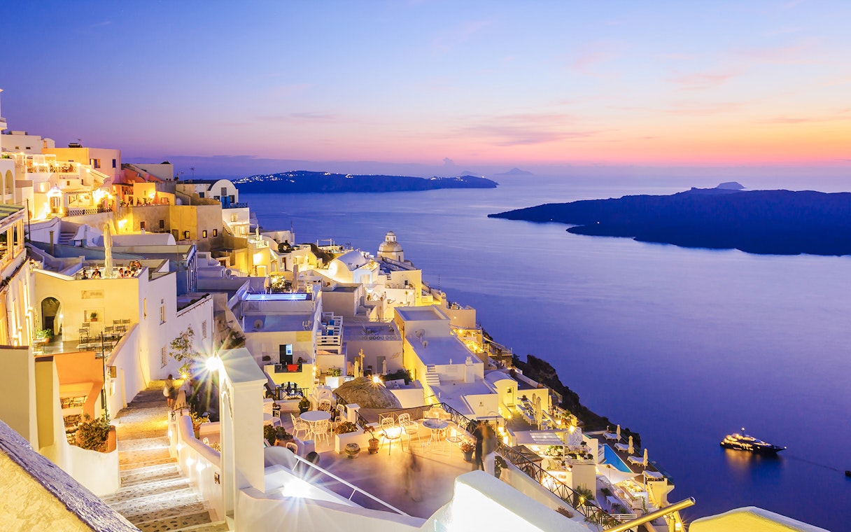 Oia village overlooking the sea at sunset, Santorini, Greece.