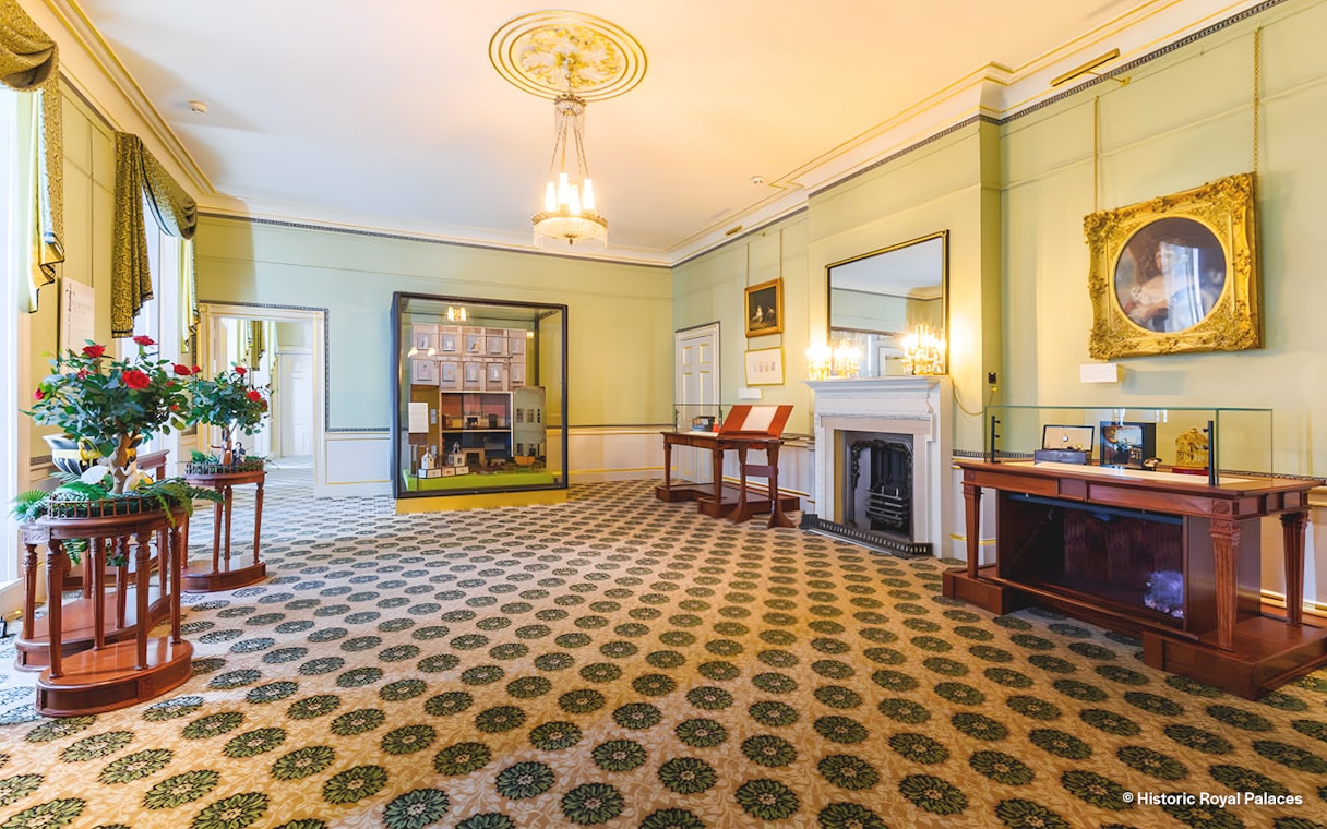 Kensington Palace interior with historical exhibits and elegant decor.