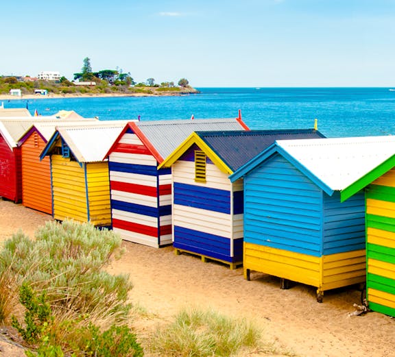 Brighton Bathing Boxes along the sandy beach with ocean view in Melbourne, Australia.